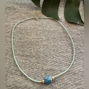 Blue beaded necklace with a touch of boho charm and glass pearl accents